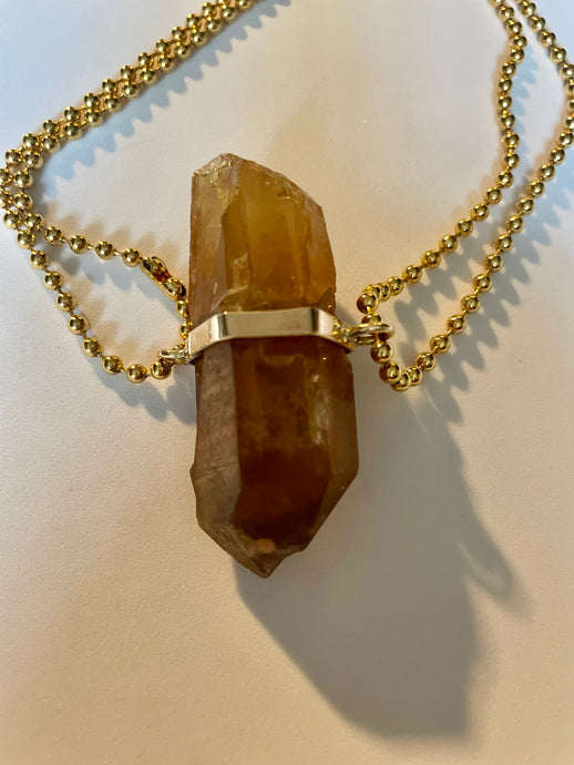 Beat Strong My Heart - Citrine Crystal Pendant on Chair